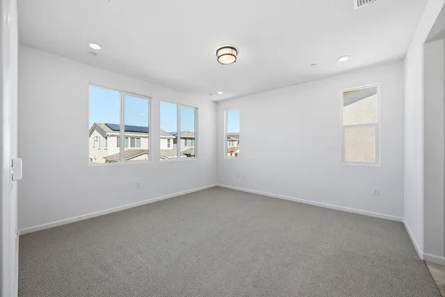 an empty room with windows and closet