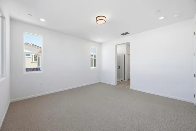 a spacious bathroom with a double vanity sink a mirror and a shower