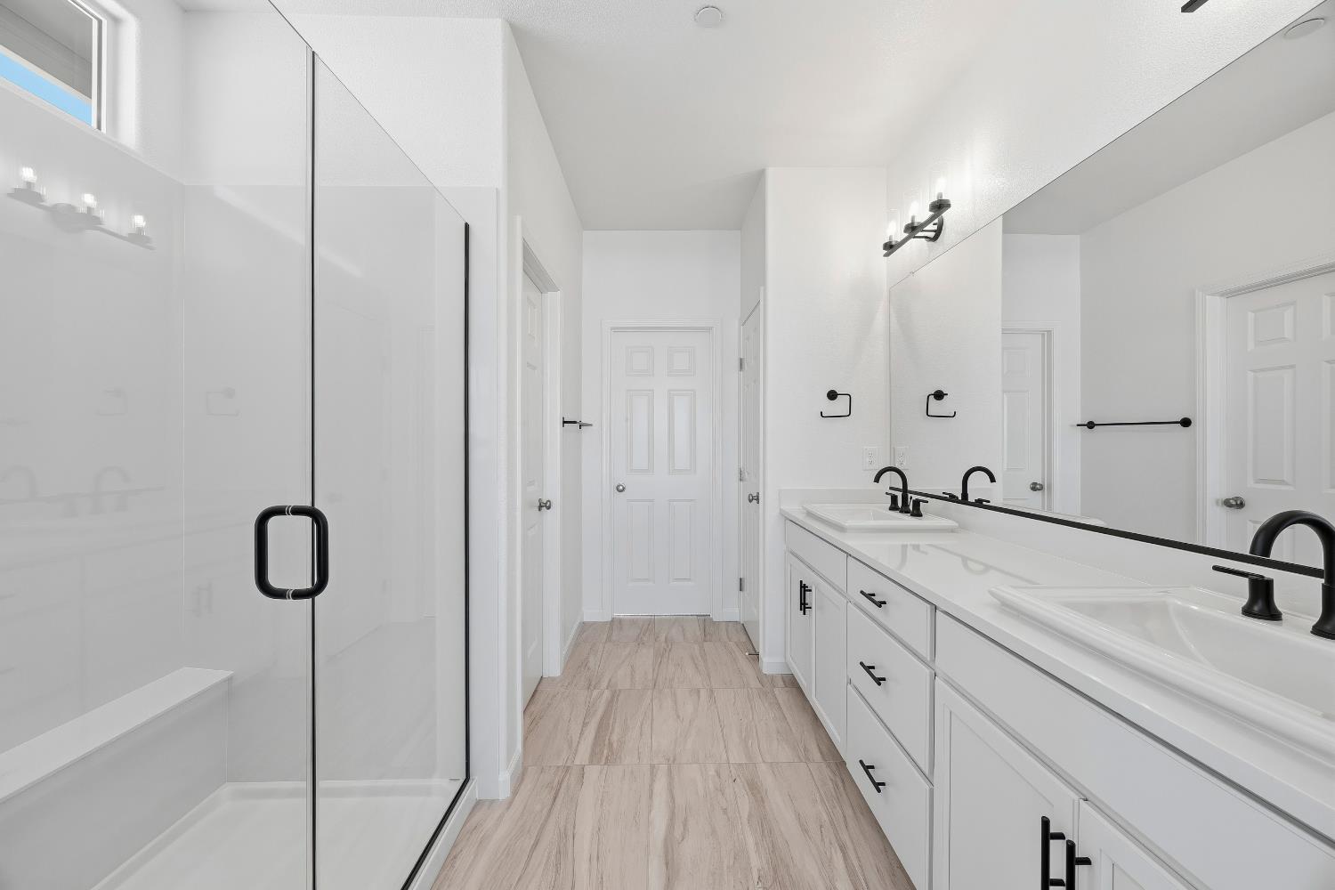 4401 Canyon Coral Way Rancho Cordova, CA 95742 - Photo 20 of 23 a spacious bathroom with a double vanity sink a mirror and a shower