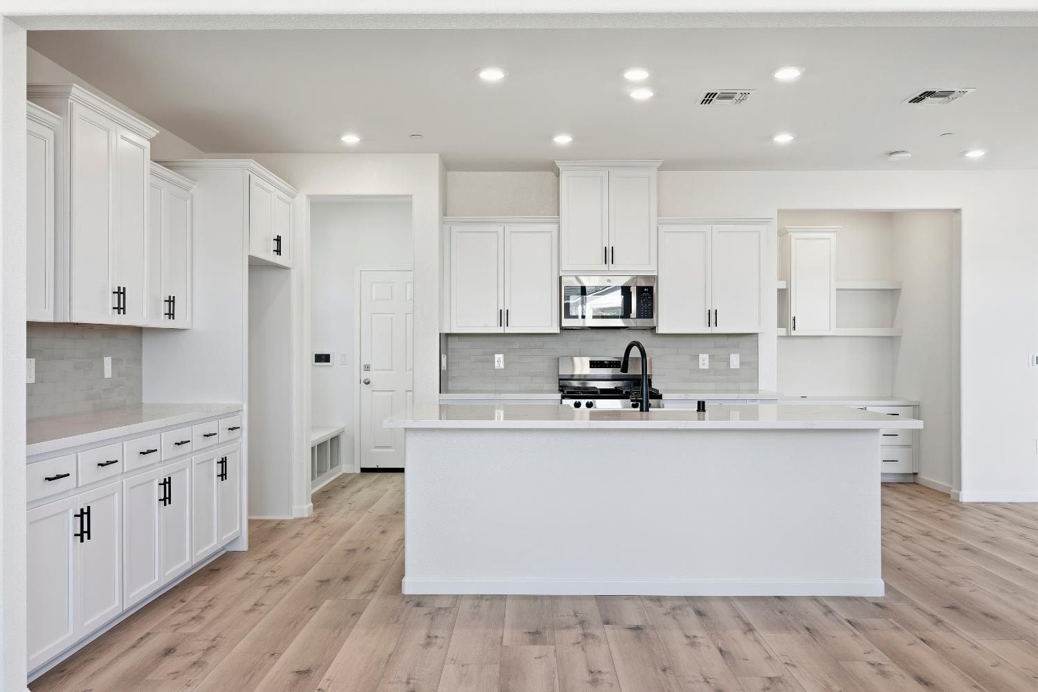 4401 Canyon Coral Way Rancho Cordova, CA 95742 - Photo 9 of 23 a kitchen with stainless steel appliances a sink stove and wooden floor