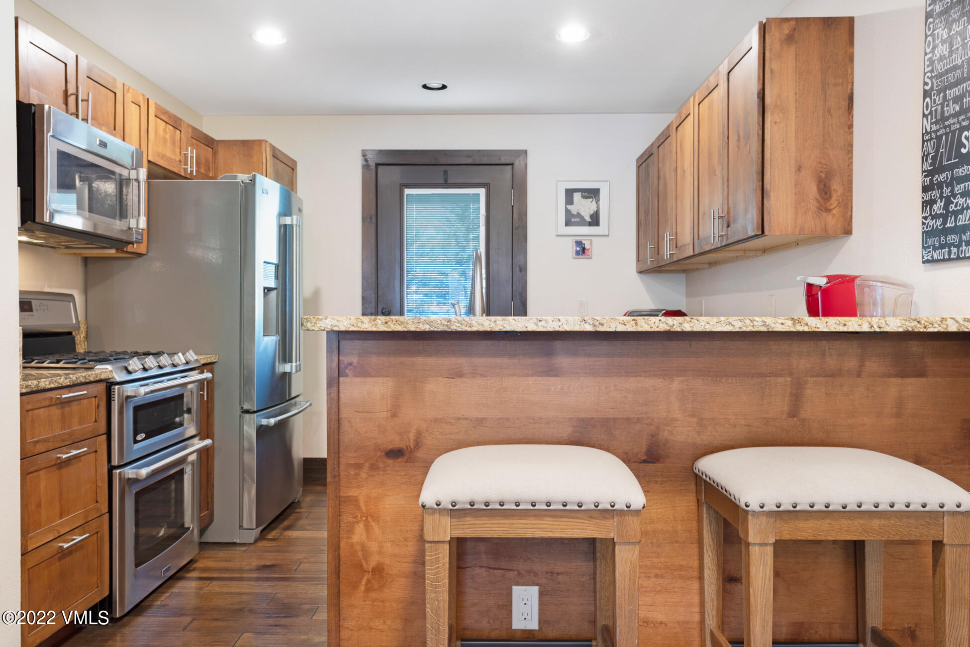 132 Eagle Road, Unit B Avon, CO 81620 - Photo 12 of 38 a kitchen with stainless steel appliances granite countertop a sink a stove and a wooden cabinets