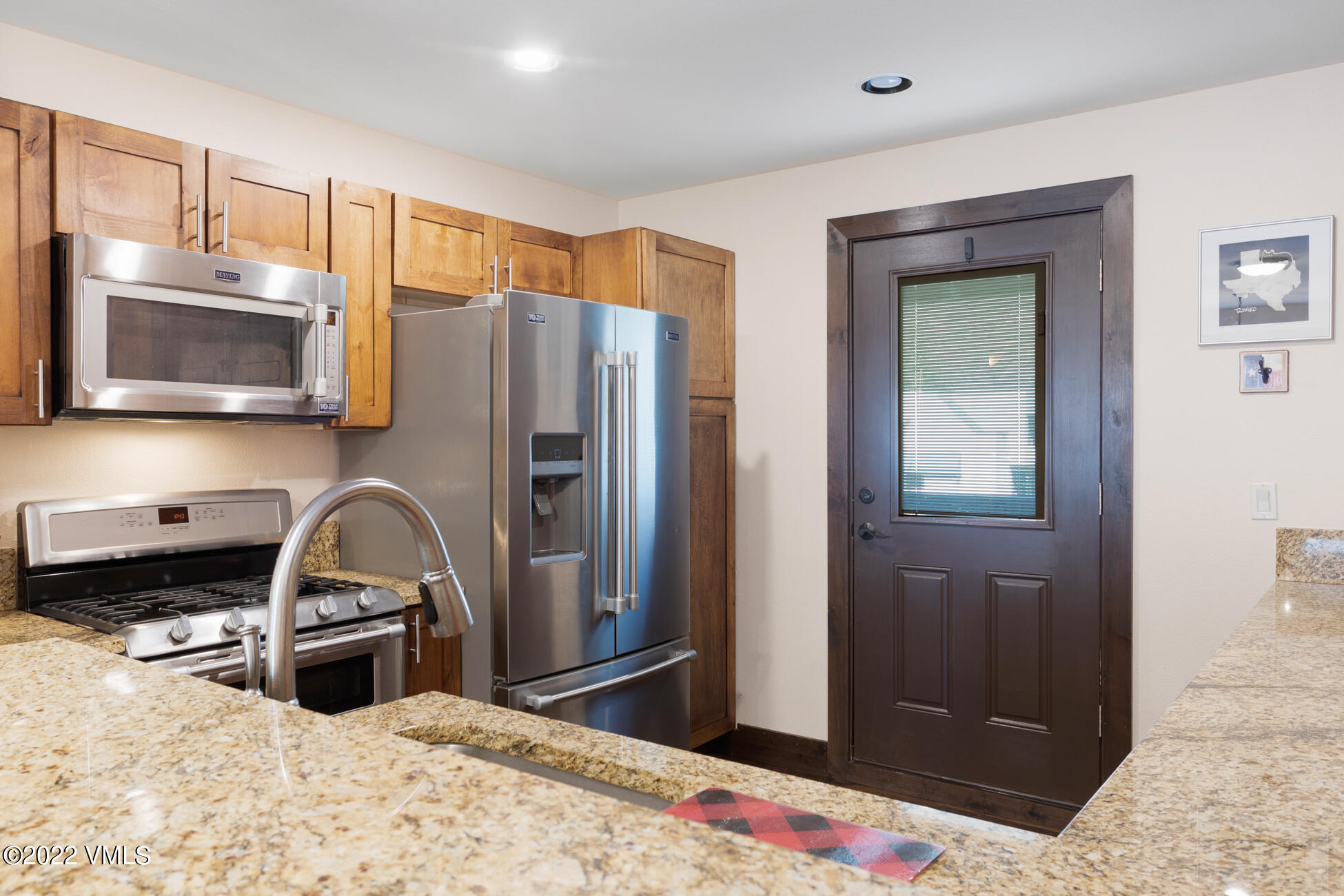 132 Eagle Road, Unit B Avon, CO 81620 - Photo 14 of 38 a kitchen with granite countertop a refrigerator and a sink