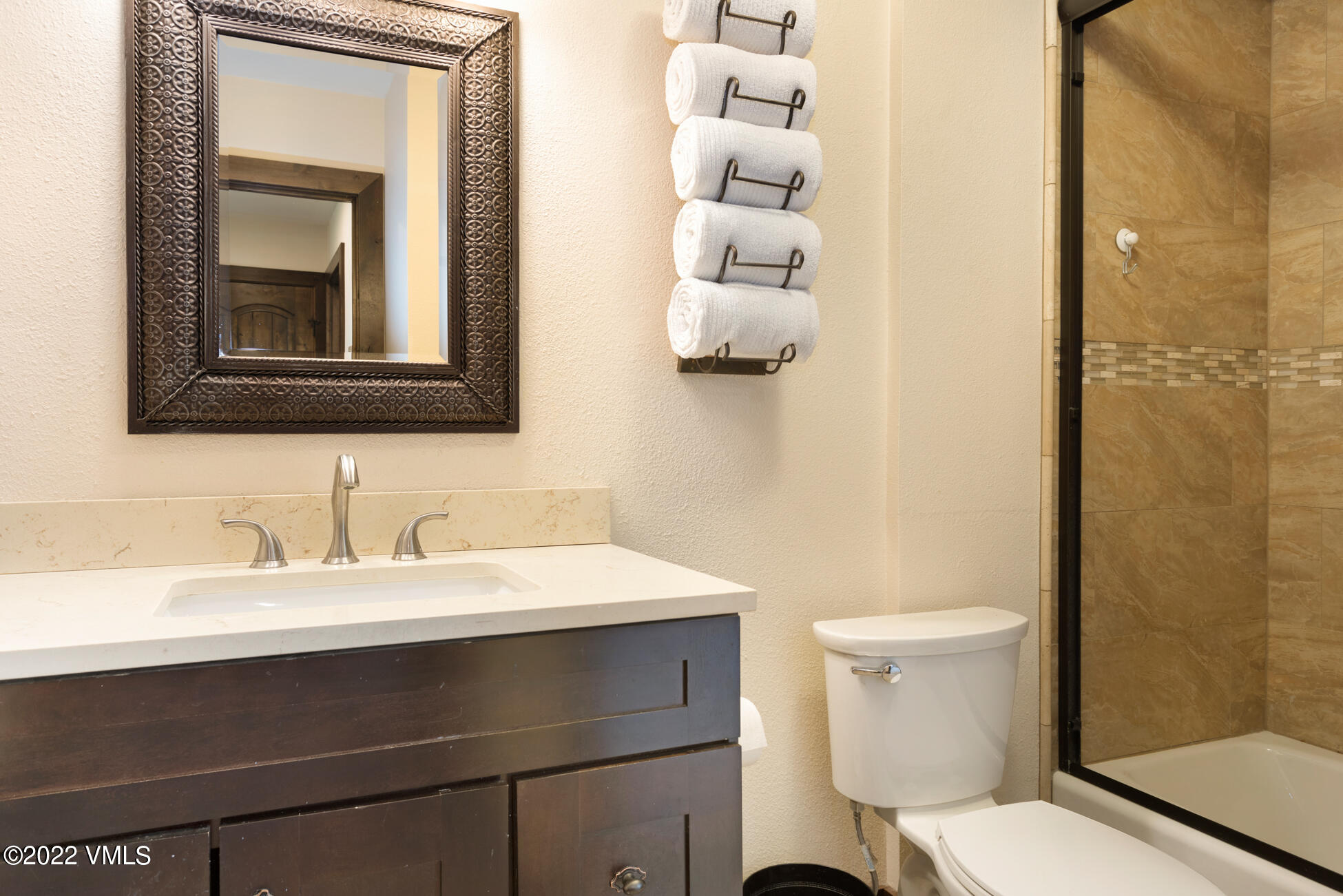 132 Eagle Road, Unit B Avon, CO 81620 - Photo 22 of 38 a bathroom with a toilet a sink and mirror