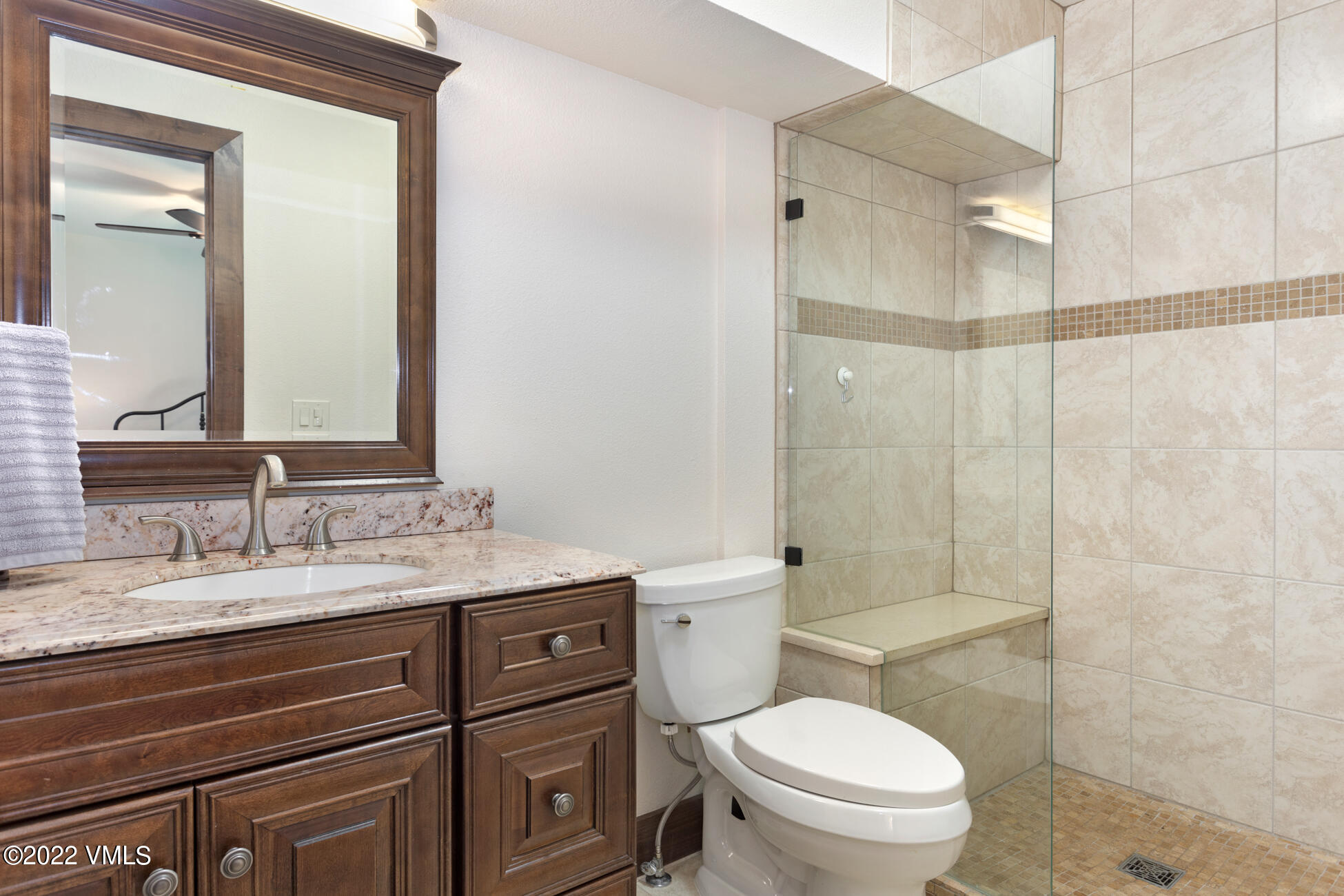132 Eagle Road, Unit B Avon, CO 81620 - Photo 28 of 38 a bathroom with a granite countertop toilet sink and a mirror