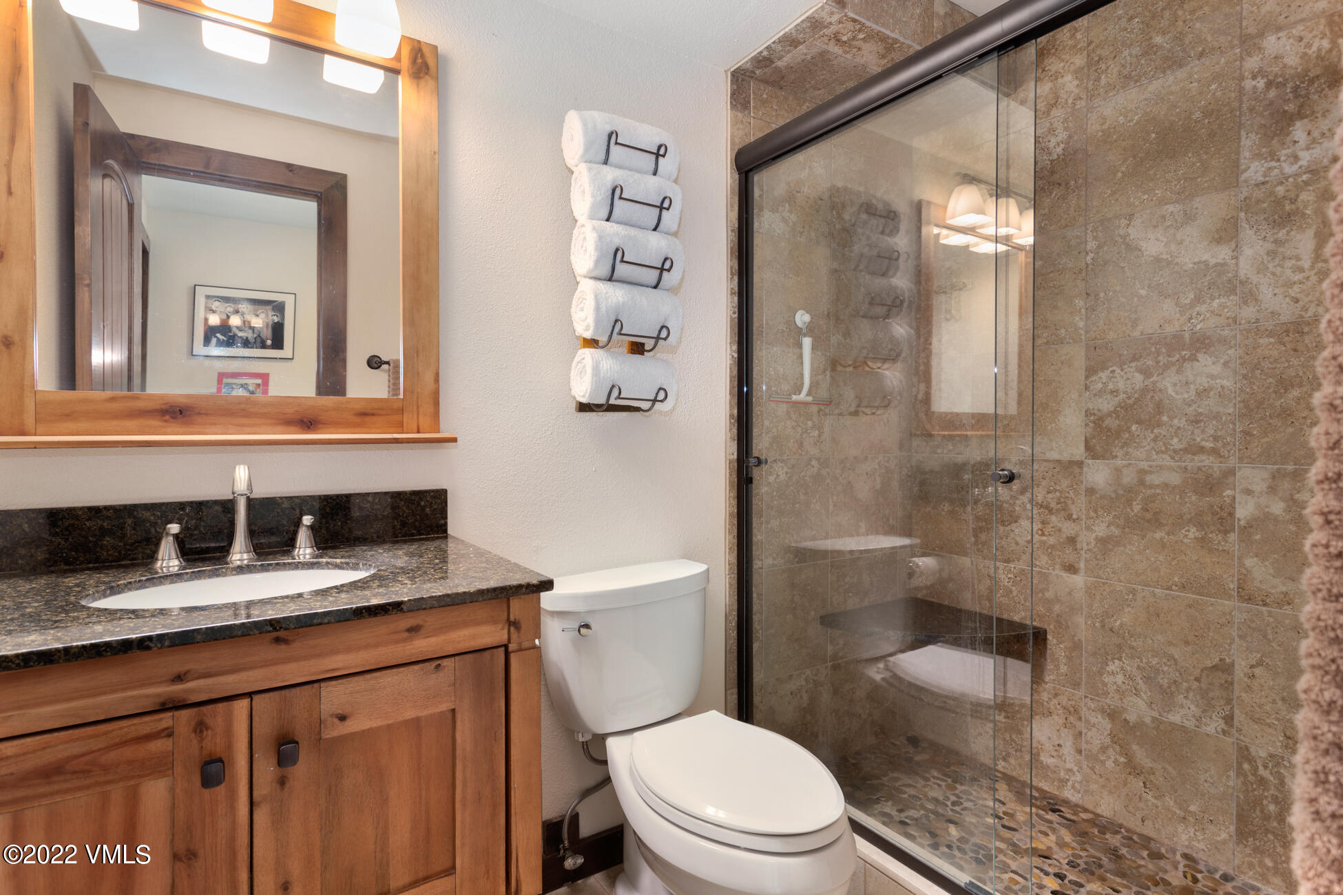 132 Eagle Road, Unit B Avon, CO 81620 - Photo 35 of 38 a bathroom with a granite countertop sink a toilet and a mirror