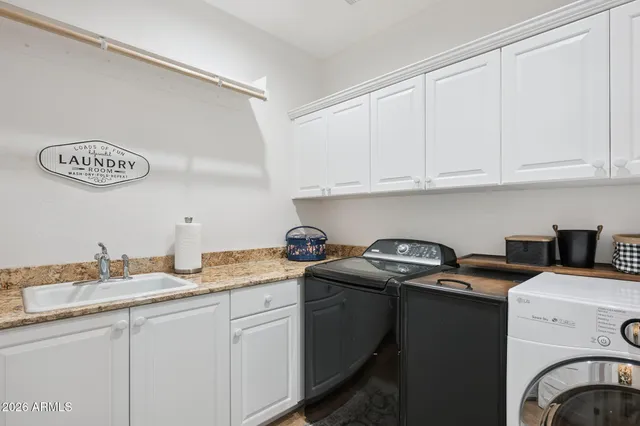a utility room with sink dryer and washer
