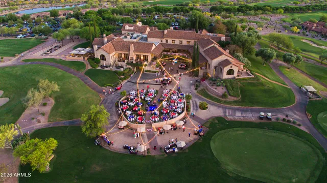 an aerial view of a house with a garden and lake view