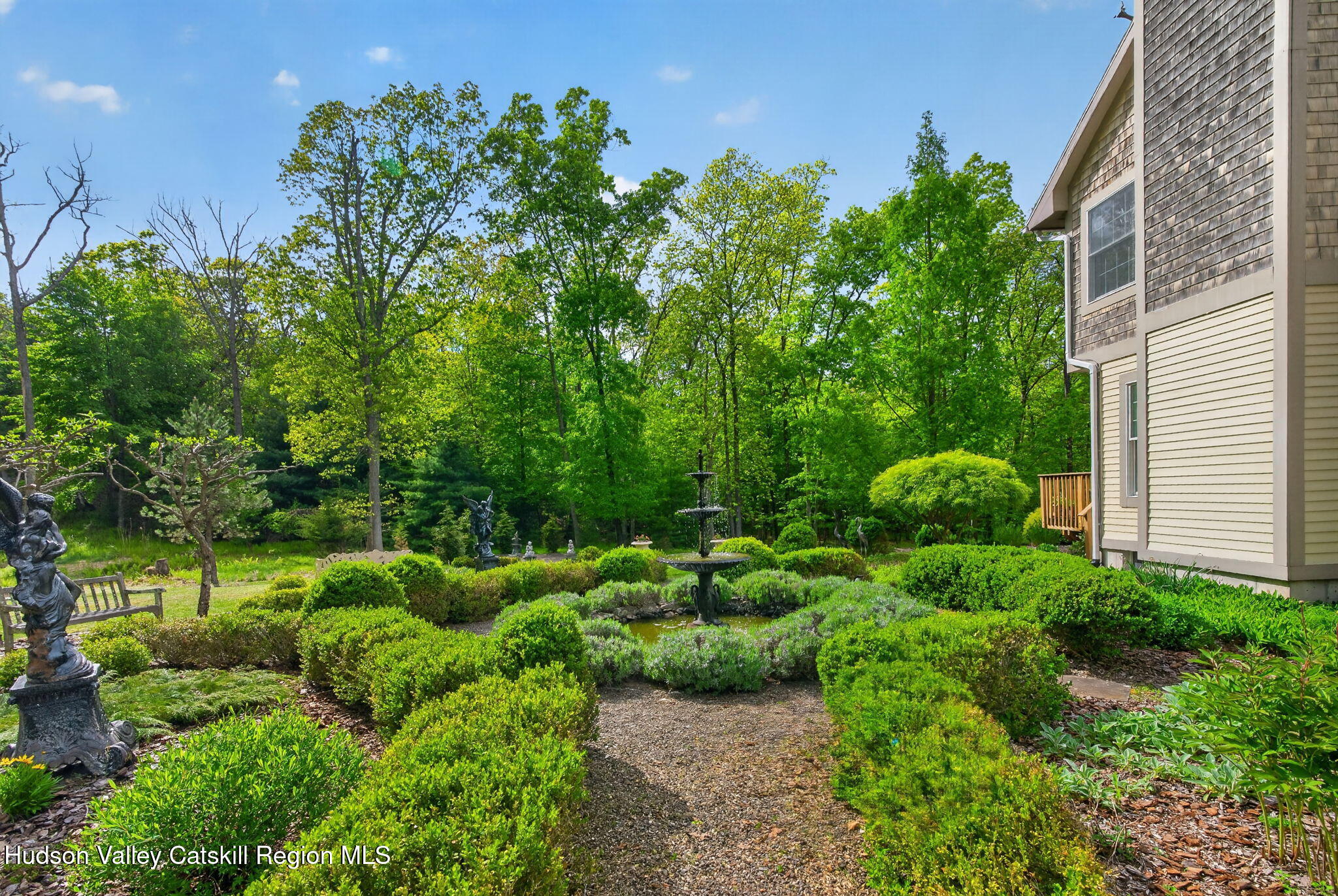 189 Bush Road Stone Ridge, NY 12484 - Photo 41 of 60 a view of a garden with plants and large trees