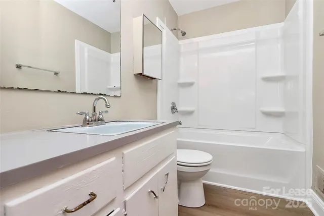 a bathroom with a sink a toilet and a bathtub