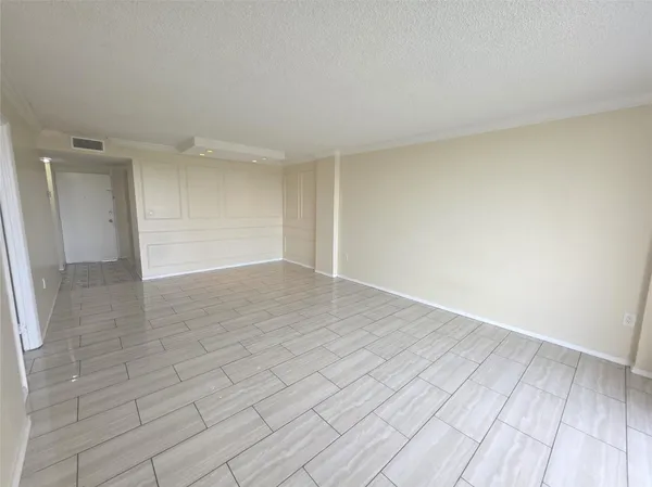 a view of an empty room and wooden floor