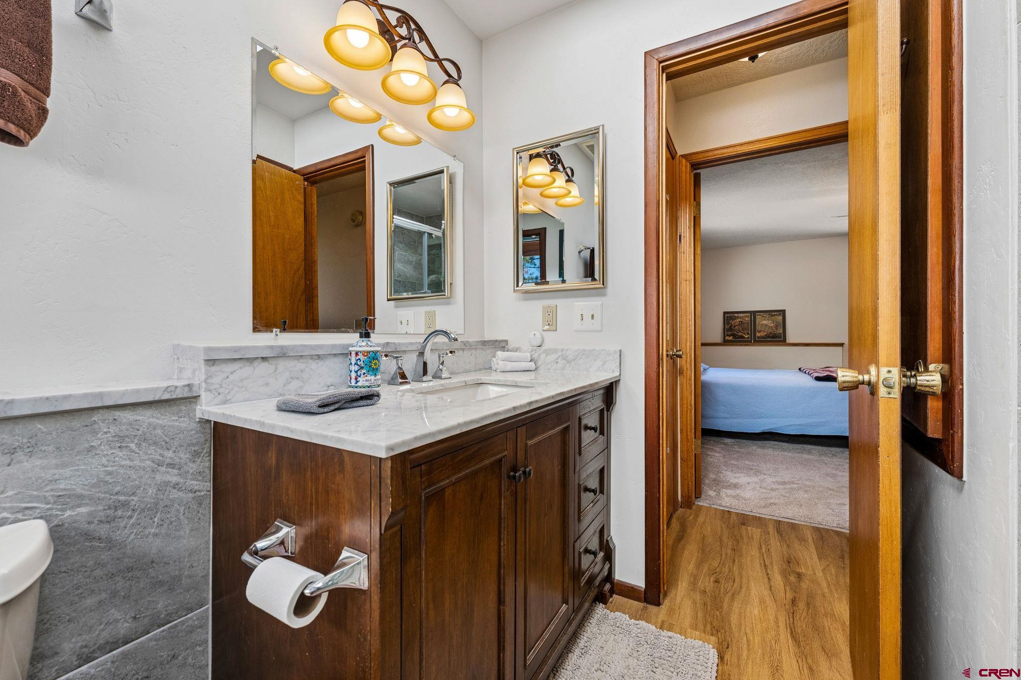 1024 Deer Ridge Drive Bayfield, CO 81122 - Photo 22 of 45 a en suite bathroom with a double vanity sink and a mirror