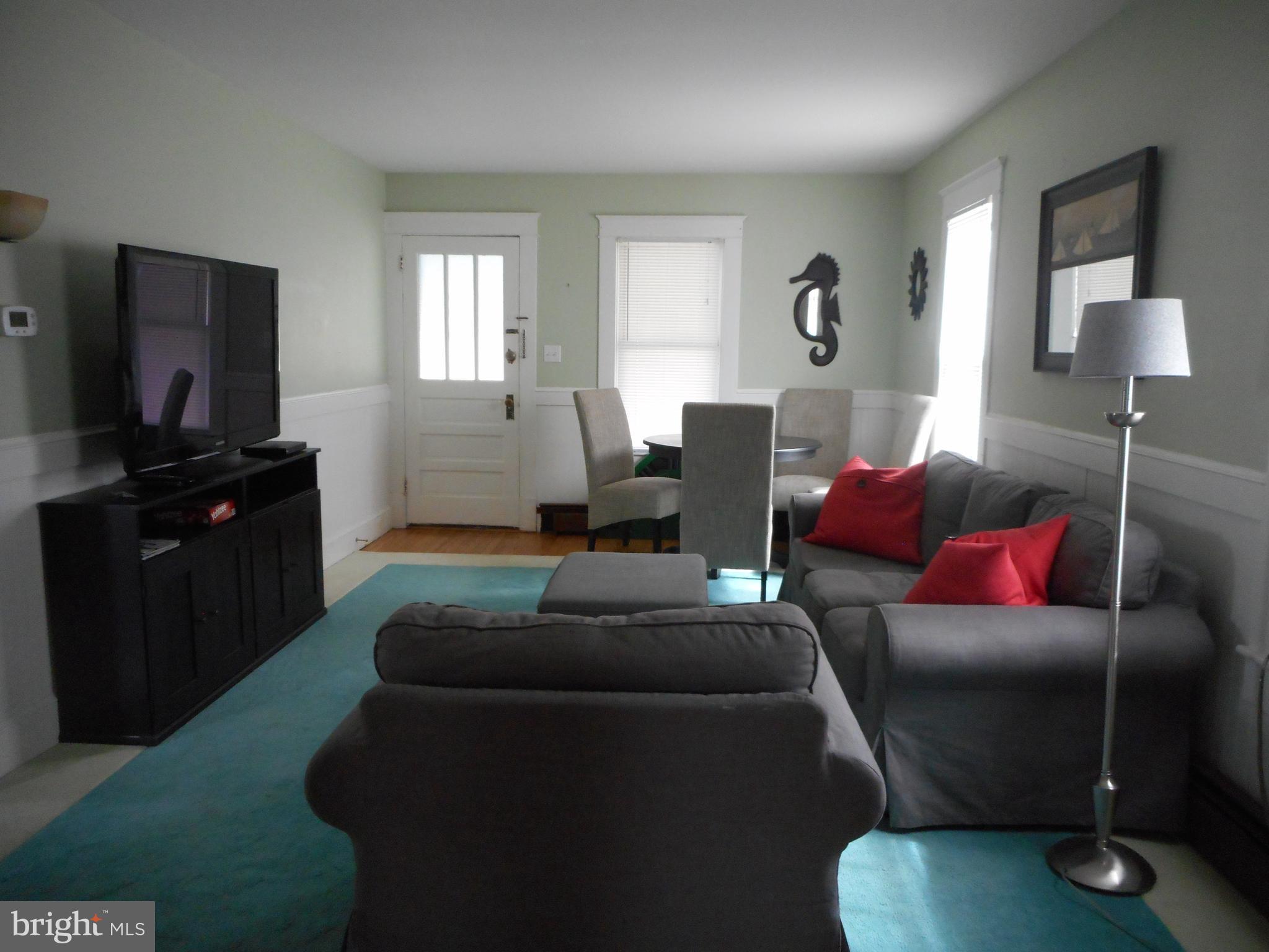 105 Hiawatha Road Cambridge, MD 21613 - Photo 2 of 15 a living room with furniture and a flat screen tv