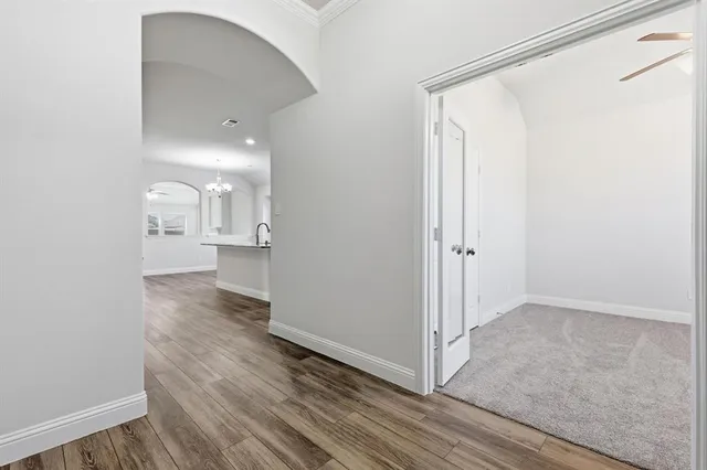an empty room with wooden floor and a bathroom