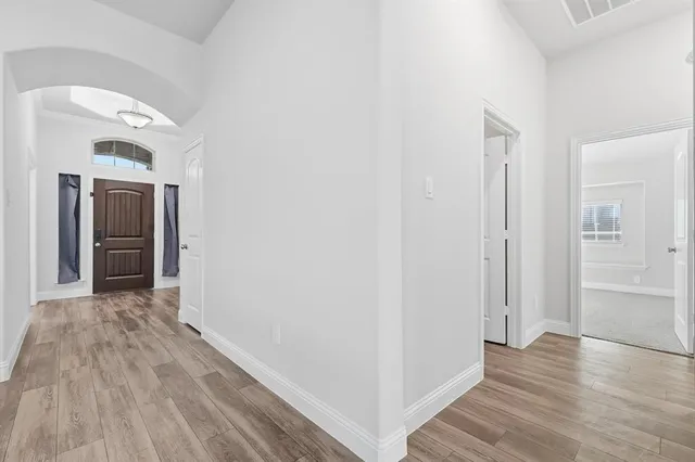 a view of hallway with wooden floor