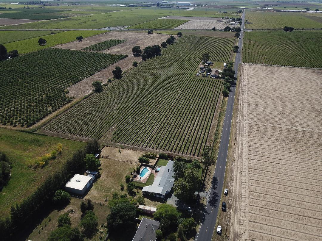4592 West Woodbridge Road Lodi, CA 95242 - Photo 71 of 71 an aerial view of a house with a yard lake and mountain view in back