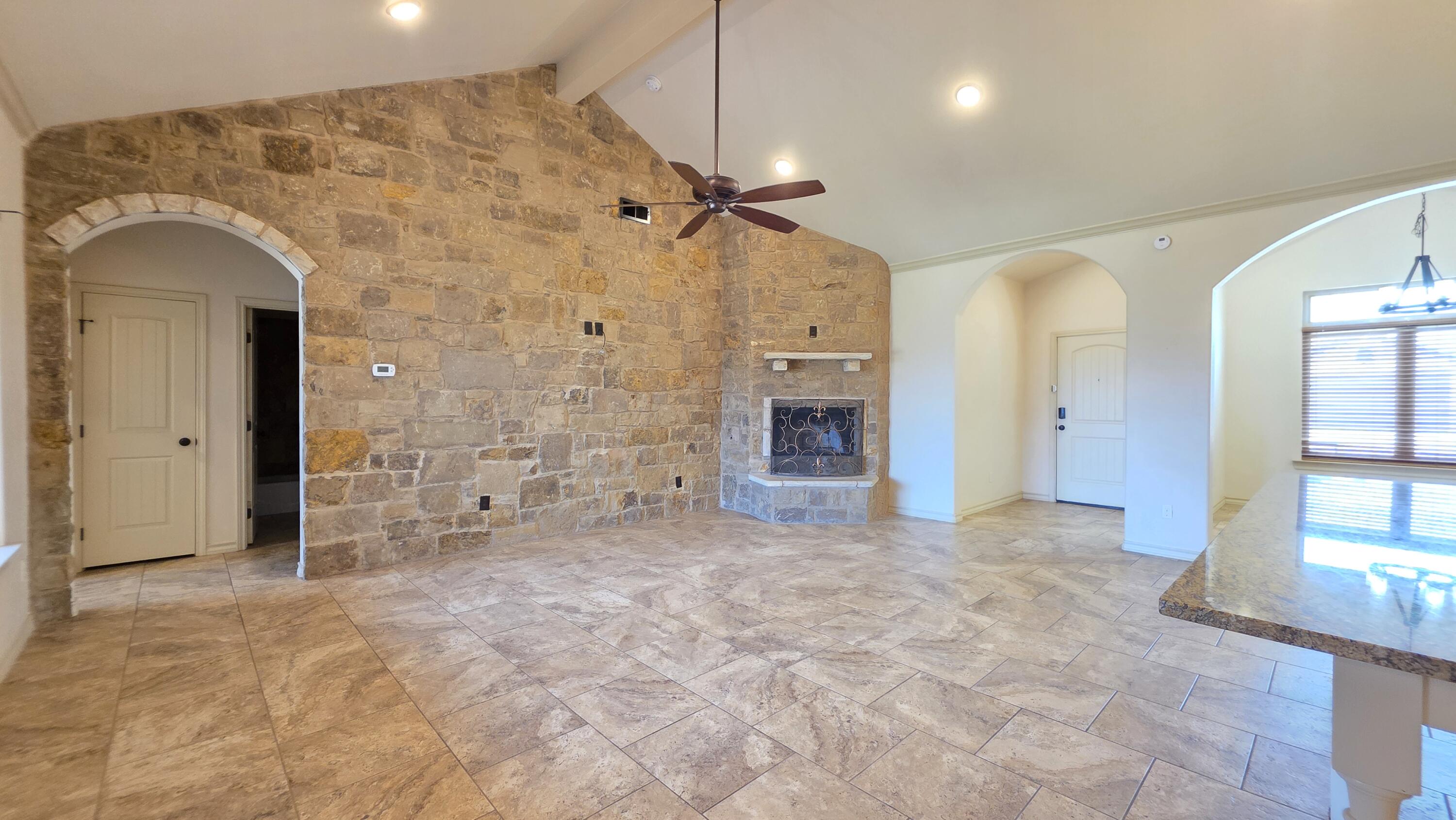 5234 Kemper Street Lubbock, TX 79416 - Photo 2 of 28 a view of empty room with a fireplace and a shower