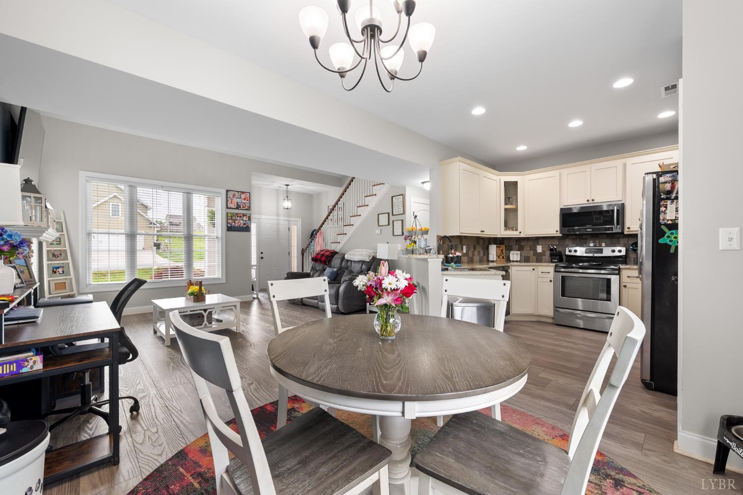 314 Cooper Way Evington, VA 24550 - Photo 12 of 44 a view of a dining room with furniture a chandelier and wooden floor