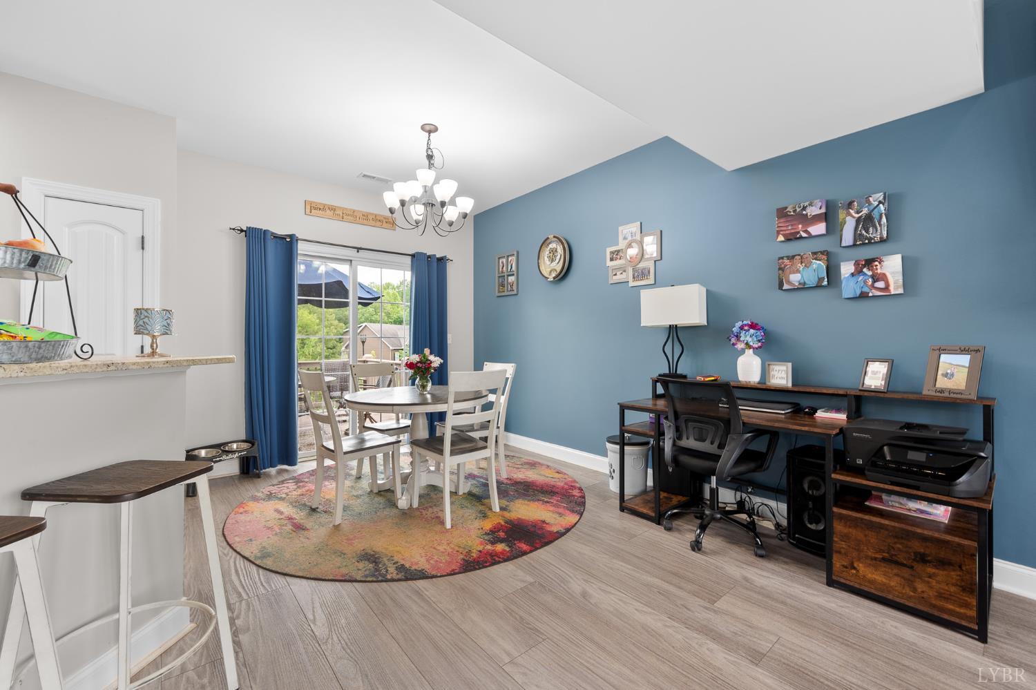 314 Cooper Way Evington, VA 24550 - Photo 15 of 44 a dining room with wooden floor and a chandelier