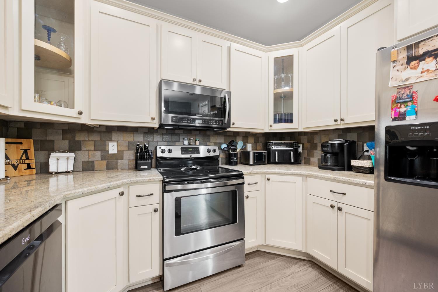 314 Cooper Way Evington, VA 24550 - Photo 17 of 44 a kitchen with stainless steel appliances granite countertop a sink a stove and microwave