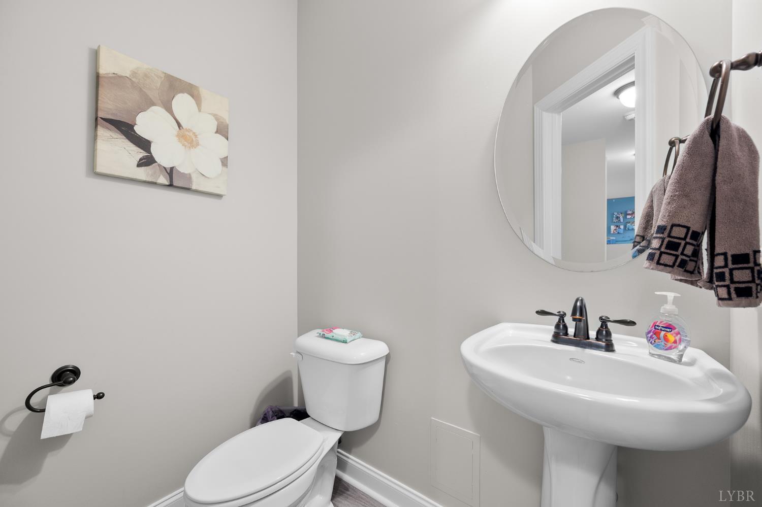 314 Cooper Way Evington, VA 24550 - Photo 19 of 44 a bathroom with a toilet sink and mirror