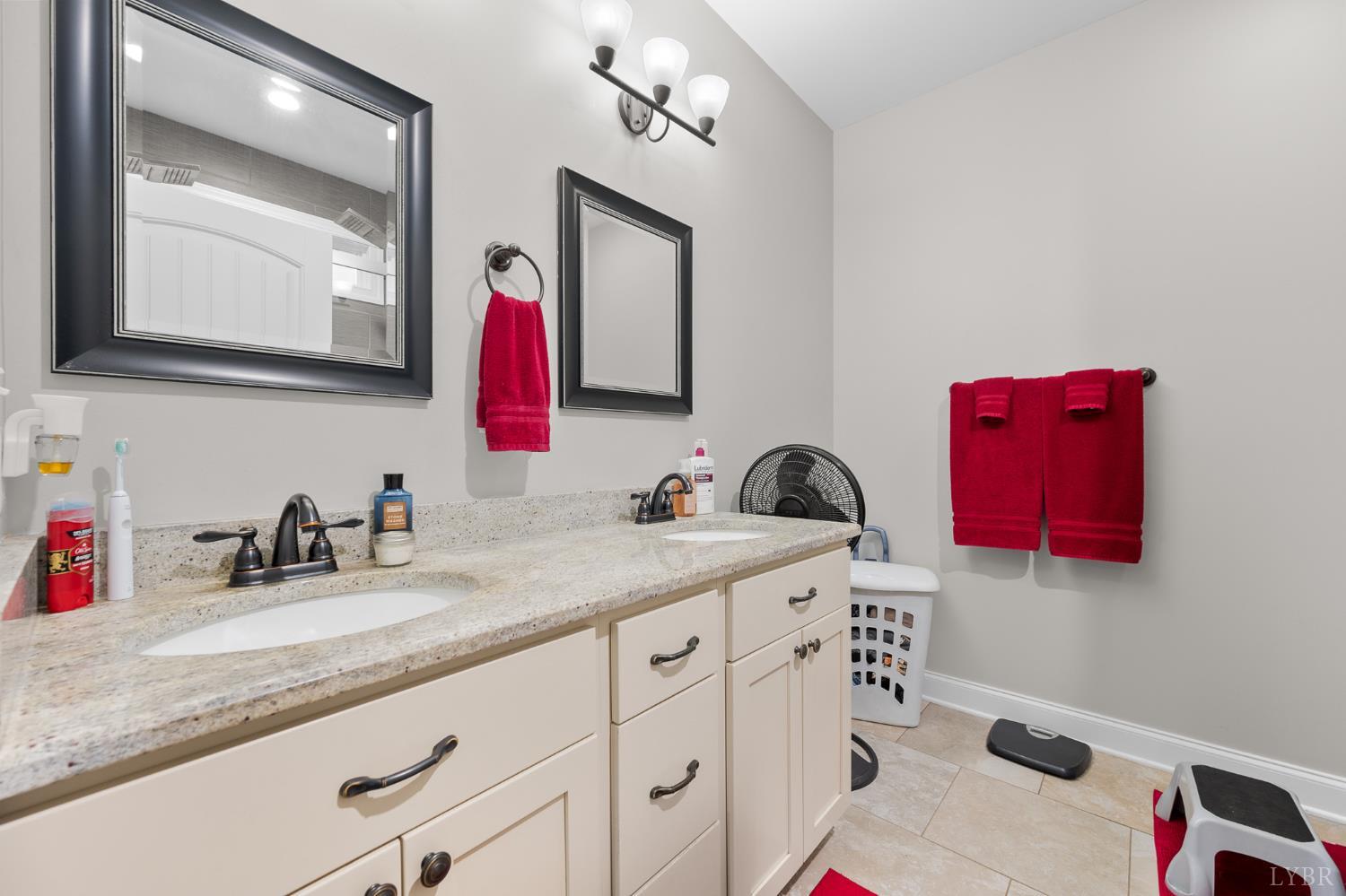 314 Cooper Way Evington, VA 24550 - Photo 23 of 44 a bathroom with a granite countertop sink and a mirror