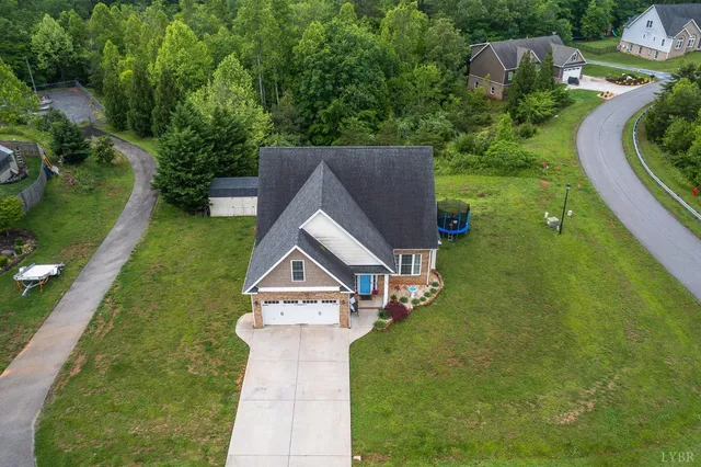 an aerial view of a house with a yard