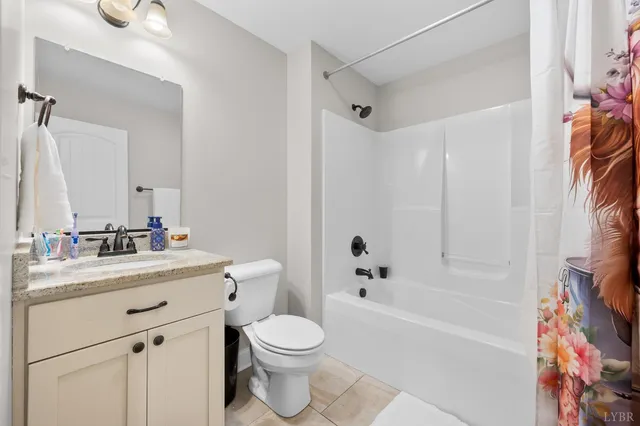 a bathroom with a bathtub shower sink vanity mirror and toilet