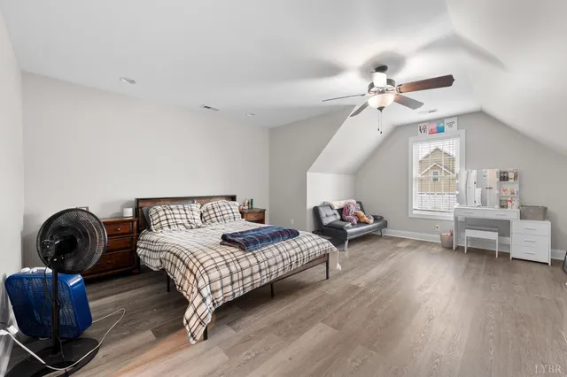 a bedroom with furniture and a wooden floor