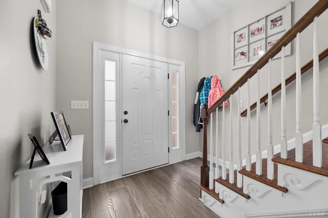 a view of an entryway with wooden floor