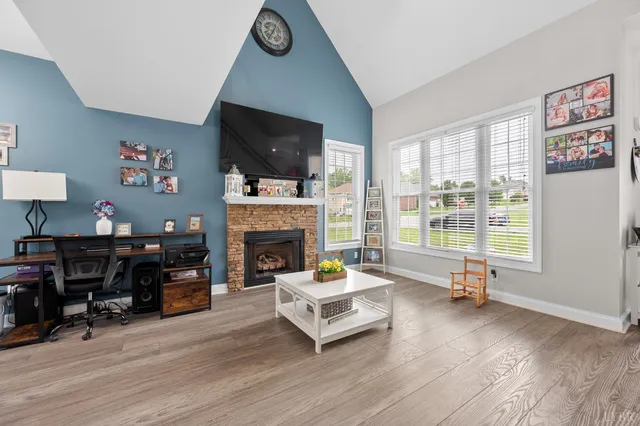 a living room with furniture a fireplace and a flat screen tv