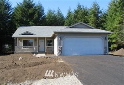 a front view of a house with a garden and yard