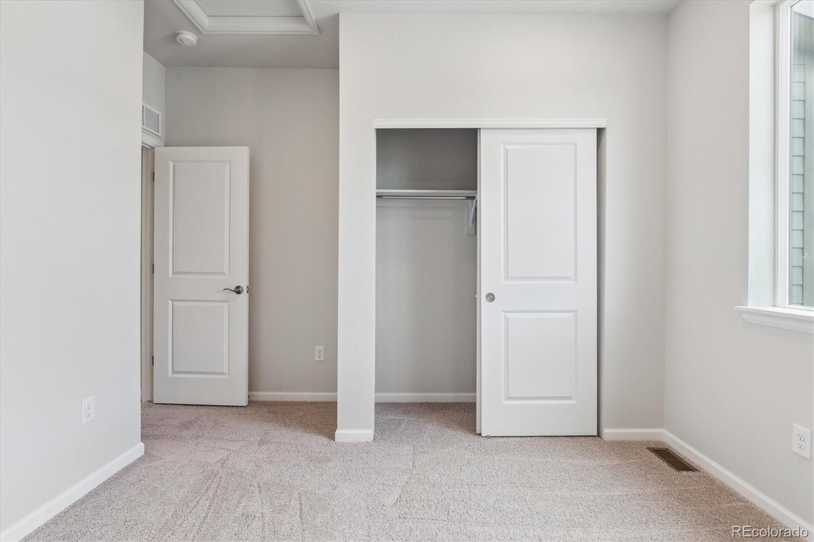 453 Interlocken Boulevard, Unit 103 Broomfield, CO 80021 - Photo 13 of 15 a view of an empty room with closet and a window