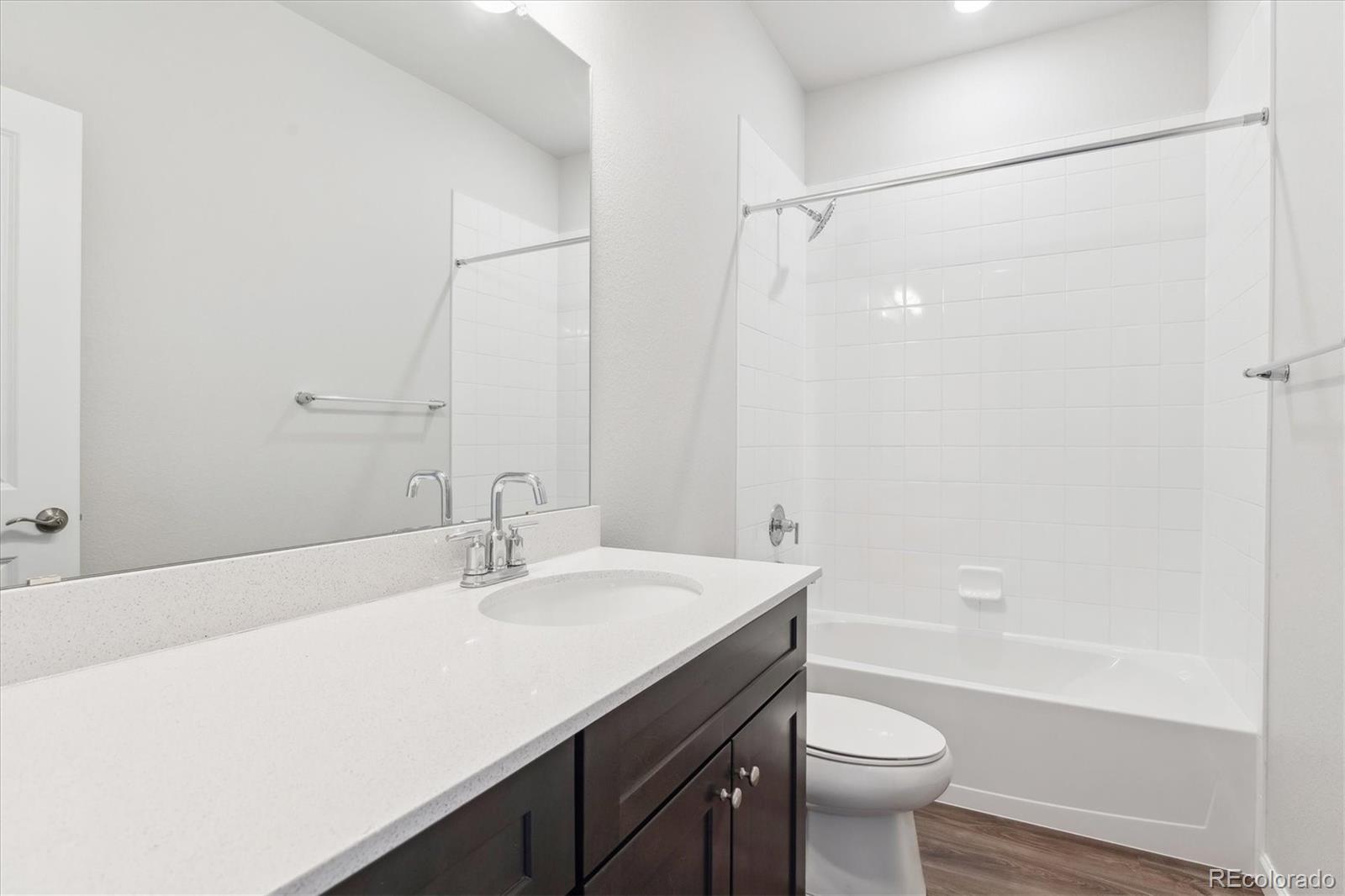 453 Interlocken Boulevard, Unit 103 Broomfield, CO 80021 - Photo 14 of 15 a bathroom with a sink a toilet and shower