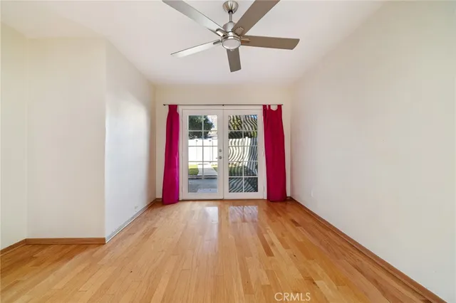 a view of a livingroom with wooden floor and a ceiling fan