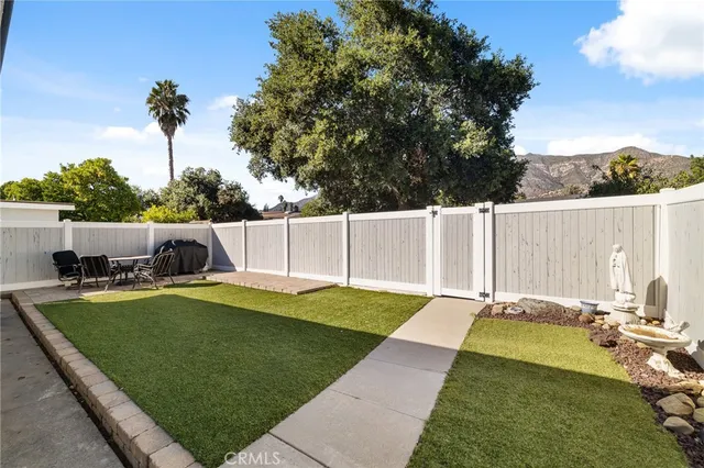a view of a backyard with swimming pool