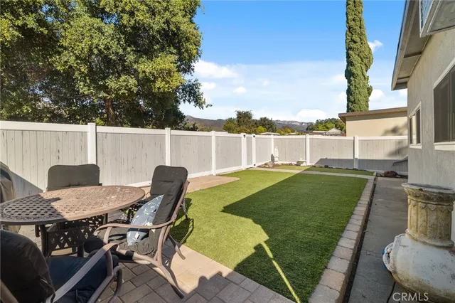 a view of a chairs and table in patio