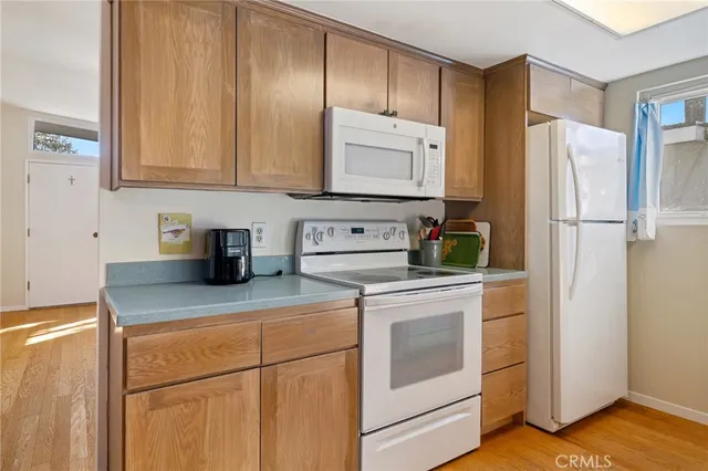 a kitchen with stainless steel appliances granite countertop a refrigerator sink and stove