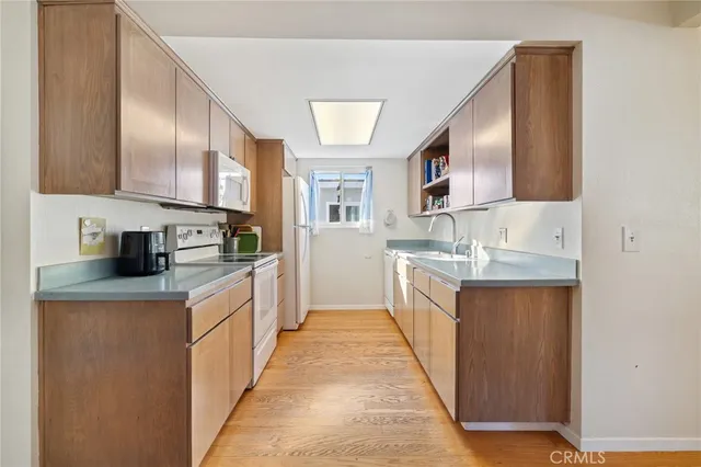 a kitchen with stainless steel appliances a sink stove and cabinets