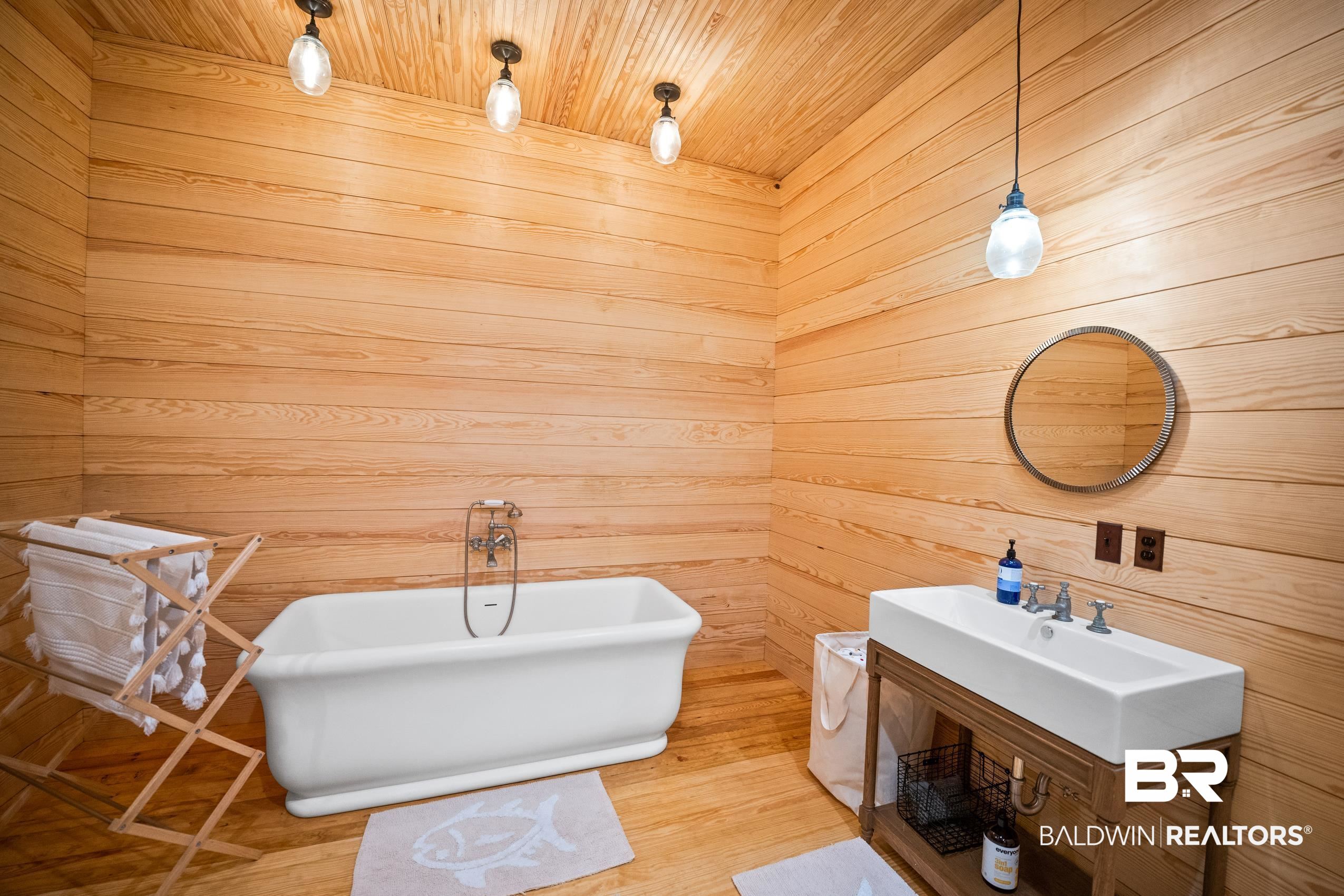 30671 Magnolia Street Elberta, AL 36530 - Photo 55 of 68 Bathroom with wood ceiling, a sink, wooden walls, and a freestanding bath
