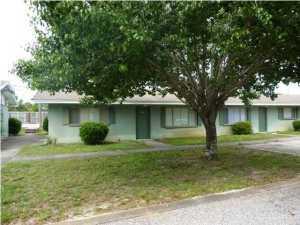 594 Florosa Court Mary Esther, FL 32569 - Photo 1 of 15 a view of a yard in front of a house with a large tree