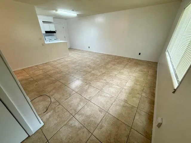 a view of an empty room and a window