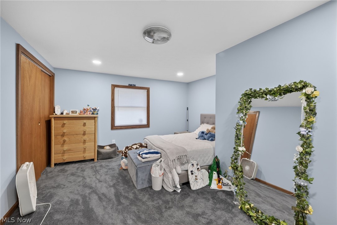 598 Randolph Road Mogadore, OH 44260 - Photo 24 of 46 Gray carpeting with light blue walls, a wood-finish door, and a single window with wood-finish trim