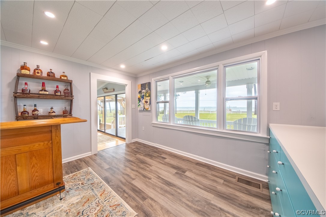 215 Riverside Drive Deltaville, VA 23043 - Photo 12 of 49 a open kitchen with kitchen island granite countertop white cabinets and refrigerator