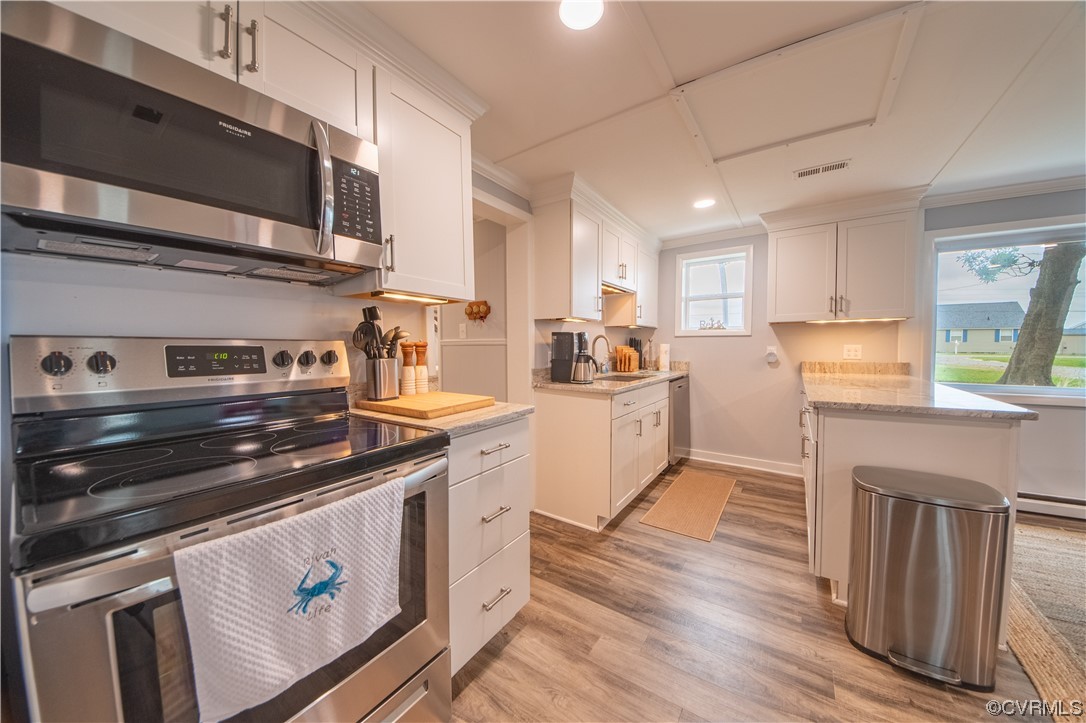 215 Riverside Drive Deltaville, VA 23043 - Photo 20 of 49 a kitchen with a stove and a microwave