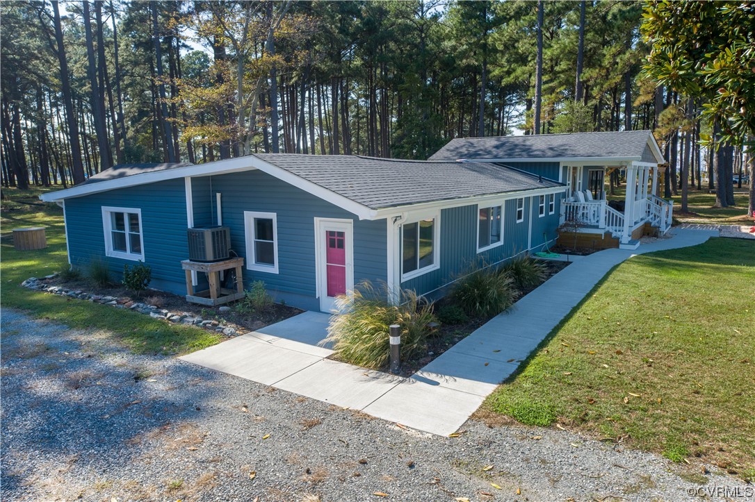215 Riverside Drive Deltaville, VA 23043 - Photo 2 of 49 a front view of a house with garden