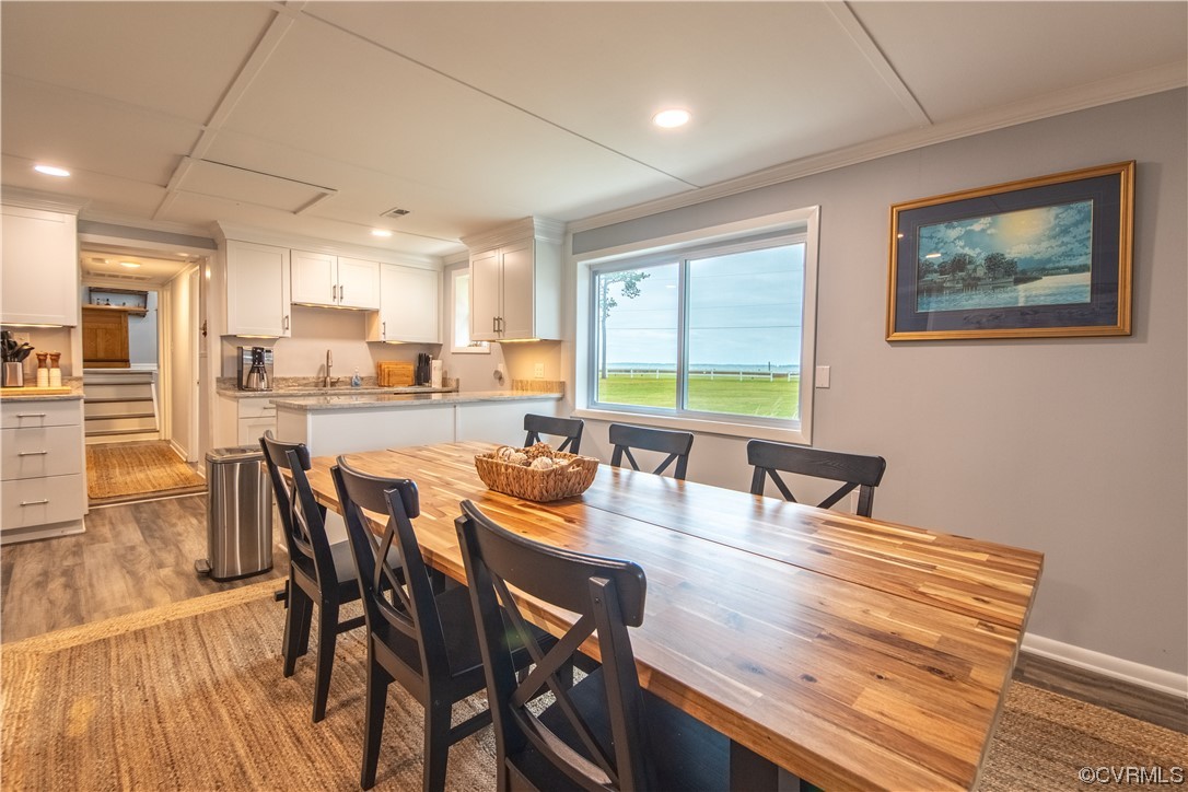215 Riverside Drive Deltaville, VA 23043 - Photo 21 of 49 a view of a dining room with furniture window and wooden floor