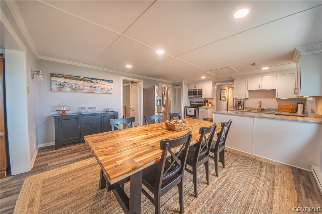215 Riverside Drive Deltaville, VA 23043 - Photo 22 of 49 a view of a dining room with furniture and wooden floor