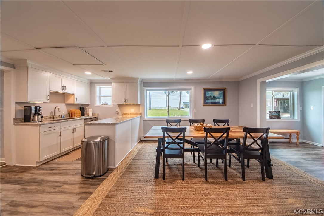 215 Riverside Drive Deltaville, VA 23043 - Photo 25 of 49 a view of a dining room with furniture and wooden floor