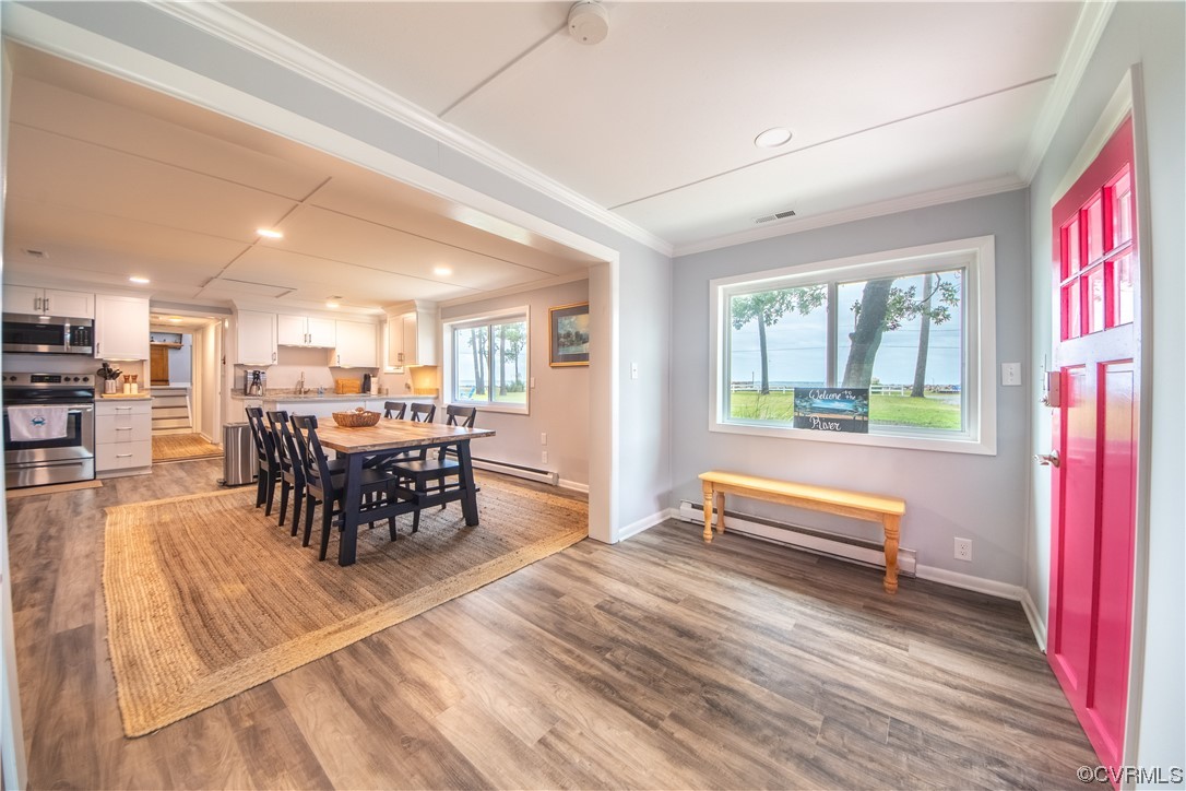 215 Riverside Drive Deltaville, VA 23043 - Photo 26 of 49 a view of a dining room with furniture window and wooden floor