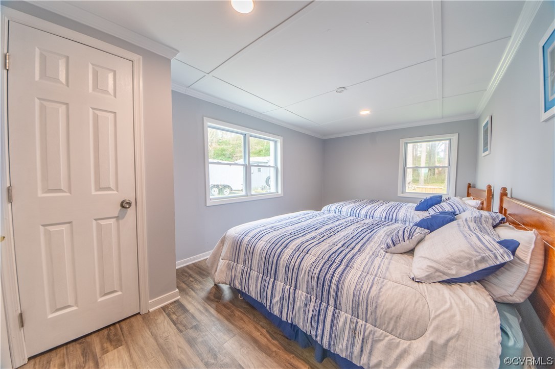 215 Riverside Drive Deltaville, VA 23043 - Photo 29 of 49 a bed sitting in a bedroom next to a window